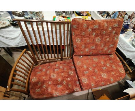 A modern Ercol light wood settee lathe back and matching foot stool, approx. 195 x 96cm 