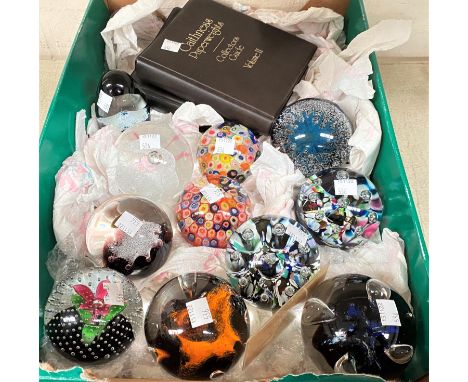 A collection of 11 modern Caithness paperweights; 2 volumes of "Collectors Guide to Caithness" 