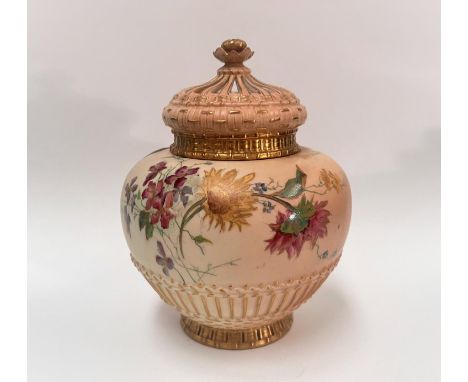 A Royal Worcester potpourri vase of squat form with reticulated and inner covers, decorated with hand painted bouquets agains