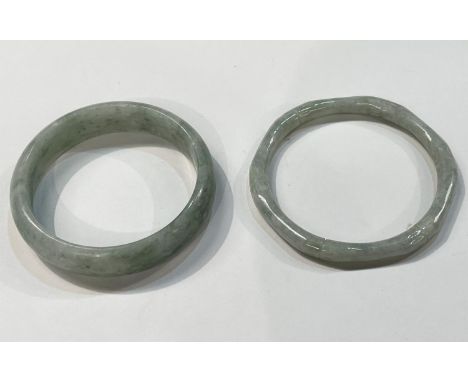 Two light Jade coloured bangles, one hexagonal and one hoop shaped. 