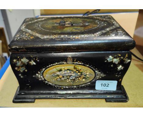 A 19th century black lacquered tea caddy with inlaid abalone and mother-of-pearl decoration 