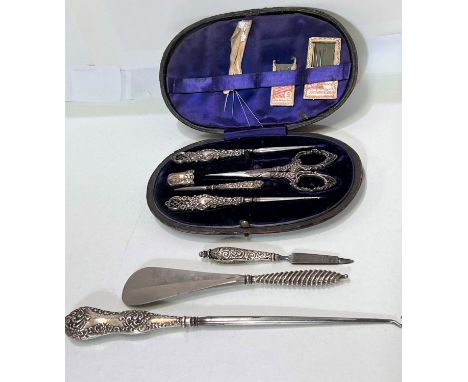 A cased hallmarked silver part needlework set; button hook etc 