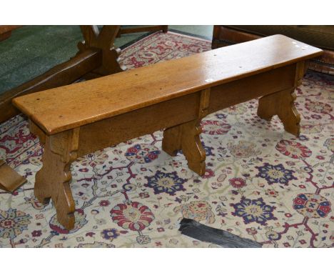 A country kitchen oak bench, plank top, three shaped supports. 48cm high x 157cm long.