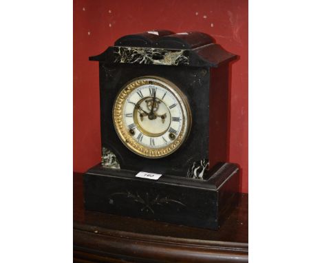 An Ansonia black slate mantel clock, double arched pediment, enamelled chapter ring, open escapement, Roman numerals, plinth 