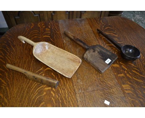 A 19th century French elm thatcher's tool; a 19th century lead mallet; a 19th century ladle; a 19th century carved wood grain