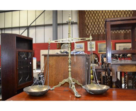 A set of 19th century brass beam balance scales, by Doyle & Sons, Borough, London, tripod base, pad feet, 56.5cm high