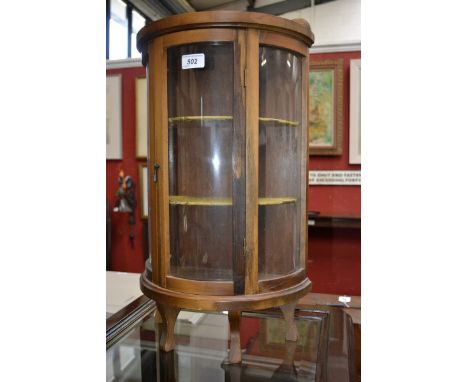 A miniature demi lune single door display cabinet, two shelf green beize lined interior, four shaped feet, 59cm high