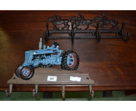 Two cast coat racks, a tractor and three running horses