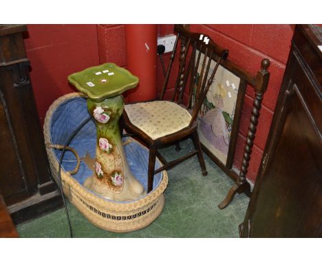 An oak barley twist firescreen; an Edwardian mahogany spindle back chair; a wicker crib; a jardiniere stand.