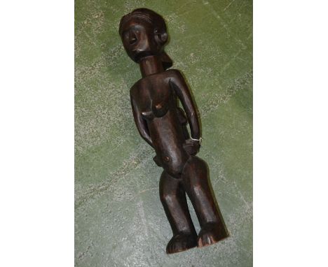 Tribal Art - a large African figure, possibly Bembe, she stands, carrying an infant on her back, 70cm high
