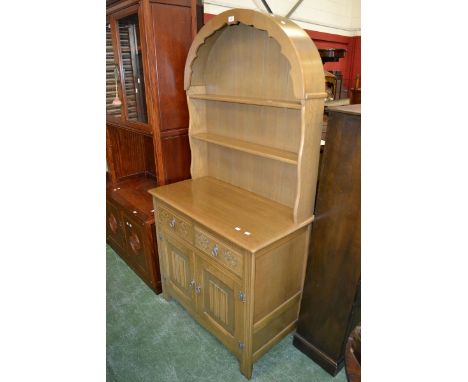 A light oak Priory style dome topped dresser by Agincourt , two shelves to top, two short drawers over two linenfold panel do