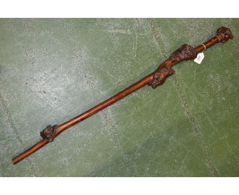 A 19th century folk art rootwood walking cane, the pommel carved as a grotesque face, 101cm long