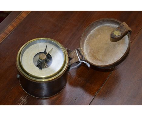 A Victorian travelling aneroid barometer, 6.5cm silvered register, leather case, 8cm diam overall, c.1890