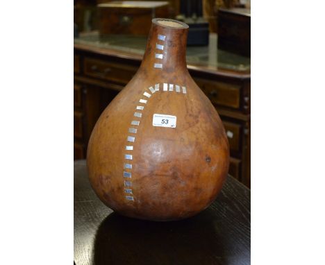 Tribal art - A large gourd inset with metal strips.