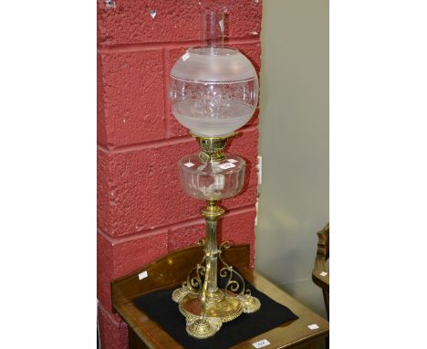 A Victorian Aesthetic Movement brass and clear glass oil lamp, faceted reservoir, shaped triangular base, engraved frosted gl