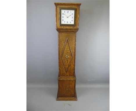 An Oak Cased Art Deco Clock, with square face and numeric dial with decorative carved ribbing around the dial, approx 23.5 x 