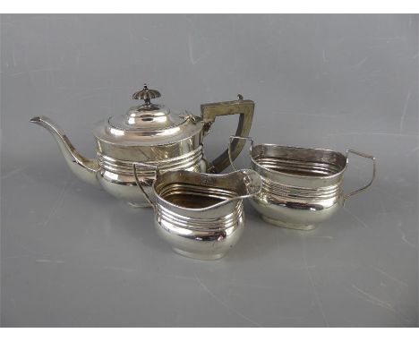 A Silver Bachelor Tea Set, including tea pot with ebony handle and finial, sugar bowl and cream jug, London hallmark, 1927, m