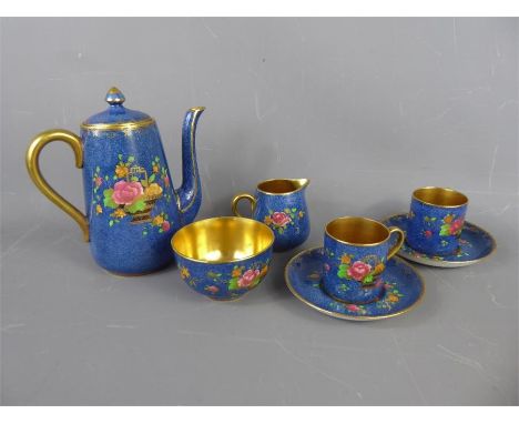 A Crown Staffordshire Coffee Service, depicting a basket of flowers on a blue background, including six cups and saucers, cof