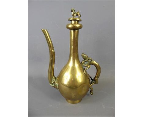 A Japanese Meiji Period Brass Ewer and Stopper, the ewer with stylized dragon form handle, the stopper with foo dog finial, a
