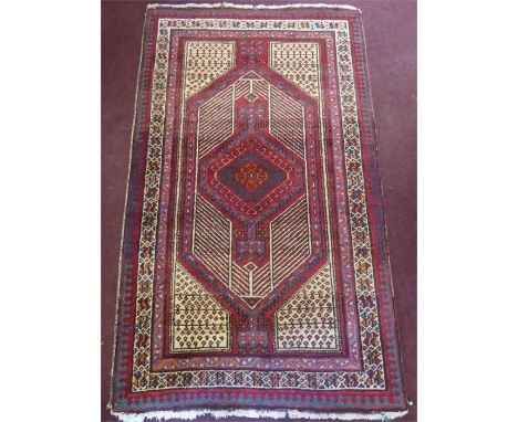 A Persian Wool Carpet. The burgundy and white carpet having a red/blue geometric design, approx 168 x 101 cms.&nbsp;