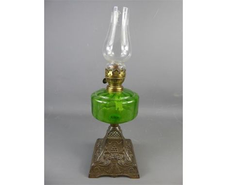 A Victorian Glass Oil Lamp, with pewter base, green bowl and clear glass funnel, approx 44 cms.