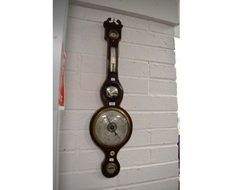 A late Victorian banjo style barometer having silvered bulls eye mirror and chased enamel dial in mahogany frame