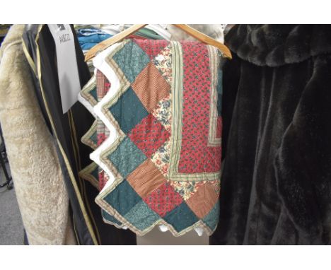A vintage patchwork quilt or bed throw