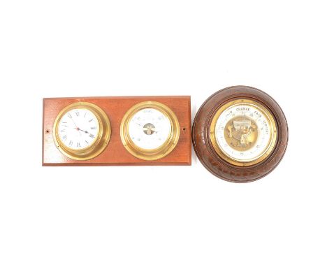 Edwardian walnut cased aneroid barometer, diameter 22cm; and a ship's clock and barometer set, on a mahogany mount.Qty: 2Cond