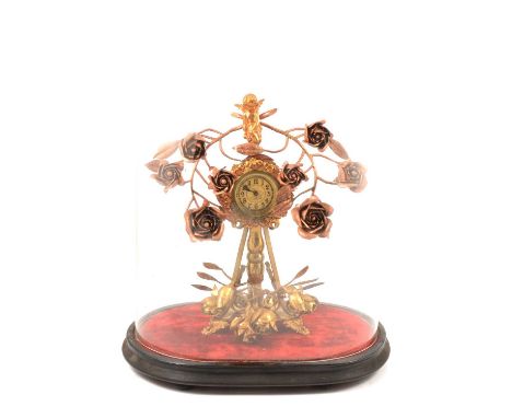 Late 19th Century French gilt metal and copper mantel clock, drum movement with circular dial on a tripod base, the frame wit