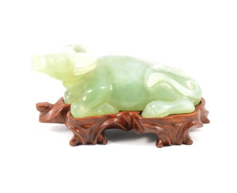 Chinese arved Jade-style figure of a reclining water buffalo, 116cm, on a boespoke hardwood stand.