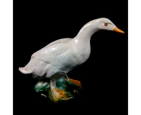An Art Pottery modelled duck figure, pink glass bead eyes, faience glaze, 18cm.Condition report:The beak has historically bee