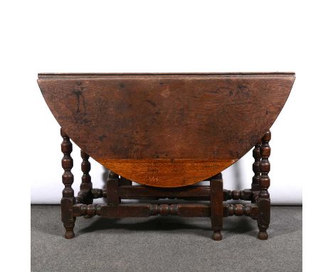 Joined oak gateleg table, basically late 17th century, oval top, bobbin moulded legs, old repairs, 119 x 143cm, height 77cm.