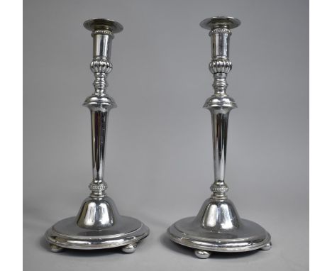 A Pair of Silver Plated Candlesticks on Circular Bases with Four Bun Feet, 26cms High 