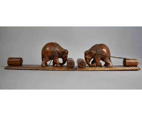 A Pair of Carved Wooden Indian Book Ends in the Form of Elephants Pushing Tree Trunk Whilst Dragging a Chained one Behind The