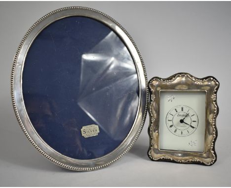 An Oval Silver Photo Frame, 27cm high Together with a Silver Framed Mantle Clock 