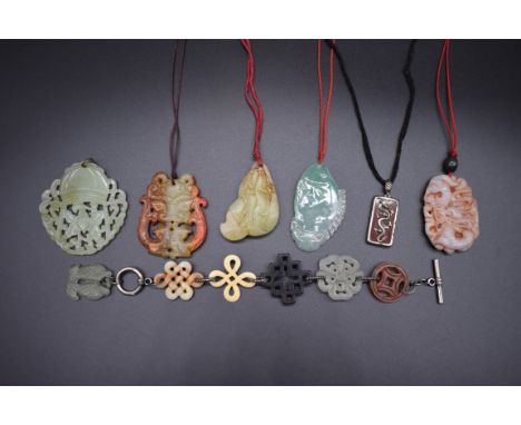 A small collection of Chinese carved and pierced jade pendants and similar.&nbsp; 