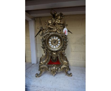 A reproduction brass mantel clock,&nbsp;43.5cm high.&nbsp; 