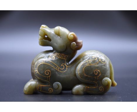 A Chinese green jade and gold inlaid mythical beast,&nbsp;8cm long. 