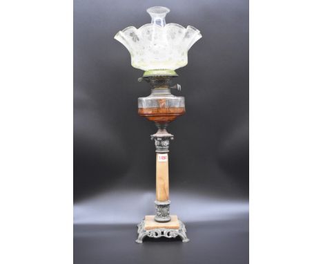 A marble and pewter oil lamp, with clear glass reservoir and etched glass shade, height excluding chimney 62cm. 
