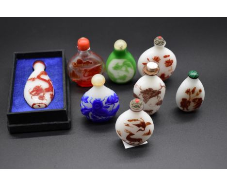 A collection of eight Chinese cameo glass snuff bottles and stoppers,&nbsp;one in fitted box.&nbsp; 