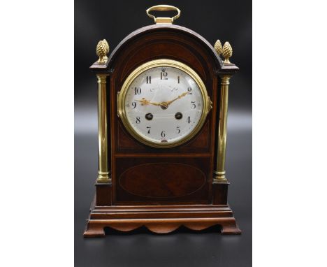 A late 19th century mahogany and inlaid mantel clock, height including handle 31cm, with pendulum. 