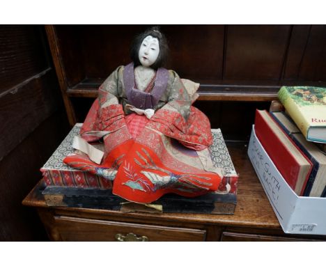 A pair of Japanese seated dolls.&nbsp; 