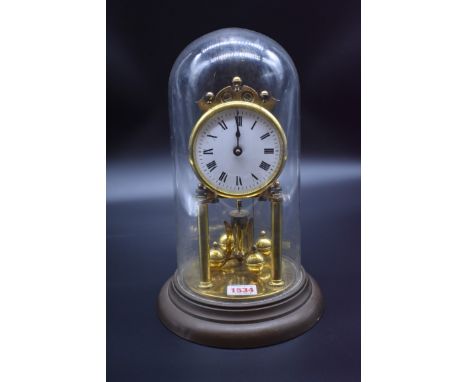 A brass anniversary clock, with enamel dial, and glass dome, total height 30cm.&nbsp; 