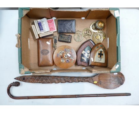 A mixed collection of items to include decorative horse brasses, decorative wooden boxes, playing cards, wooden shielded item