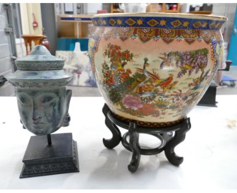 Reproduction oriental planter with peacock and bird design and carp design on inside with a reproduction Tibetan head ornamen