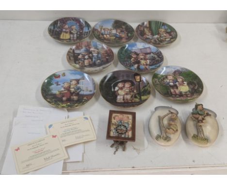 Goebel Hummel to include two wall hanging pockets No 360/B, and 360/G, a small wall hanging clock, together with eight collec