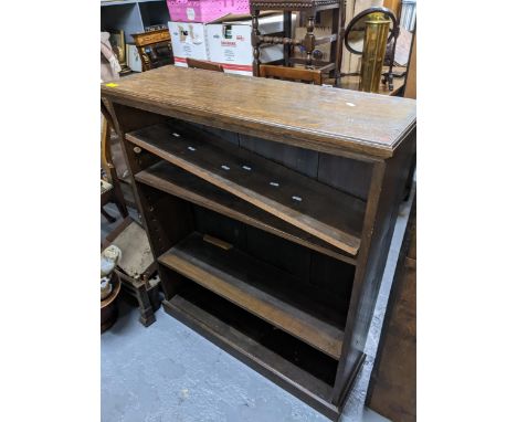 Two 20th century bookcases, an oak open bookcase with three adjustable shelves on plinth base 107cm x 91.5cm x 30.5cm, and a 