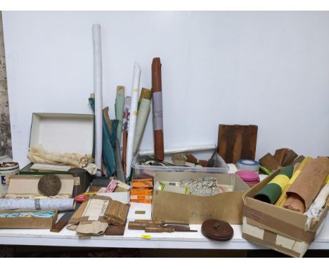 A selection of bookbinders materials and accessories to include book, cloths, stain cords, headbands, tools, and various othe