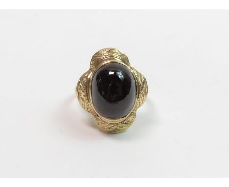 A cabochon garnet ring, with glazed locket back and stamped ‘15c’, to a later added unmarked shank                           