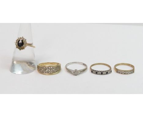 A 14 carat gold diamond set dress ring, 3.5 g gross; with a 9 carat white gold single stone diamond ring; two other 9 carat g